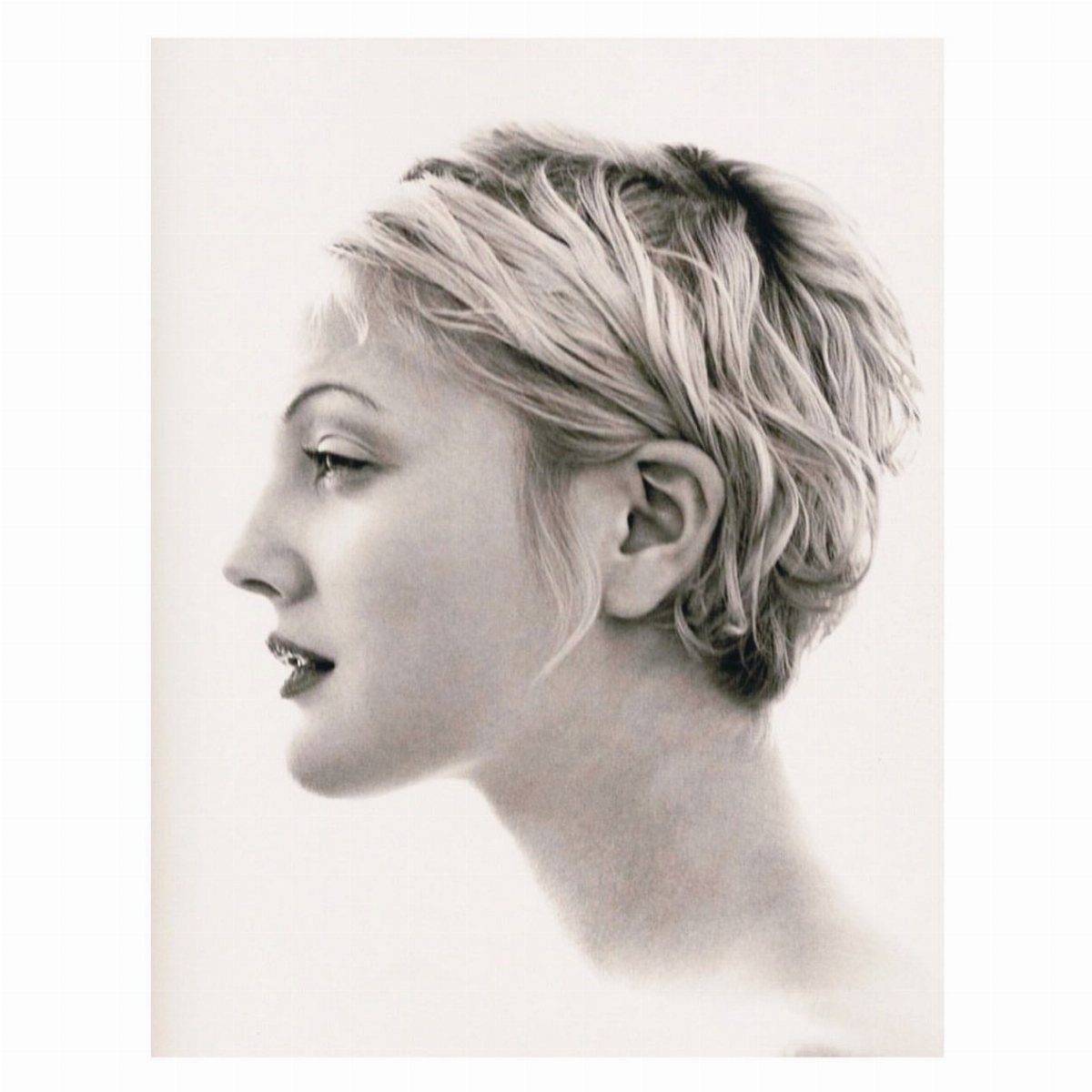 90s Hairstyles Short and 6 Ideas We Still Want to Copy 3 A woman in profile showcasing a short, textured pixie cut with layered blonde hair.