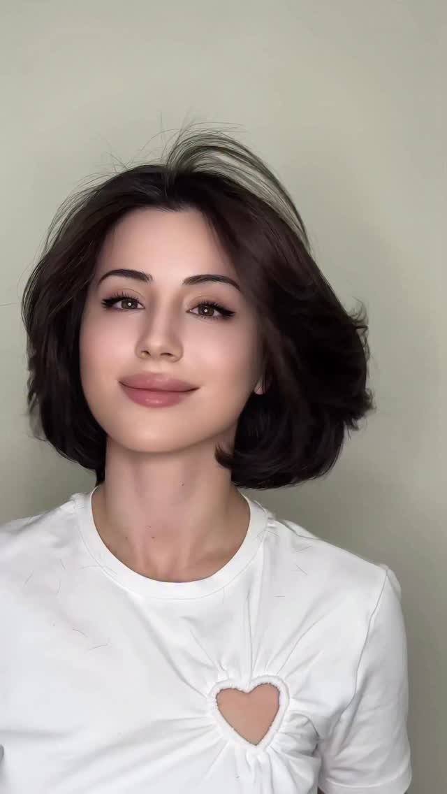 90s Hairstyles Short and 6 Ideas We Still Want to Copy 1 A woman with a voluminous dark brown short bob hairstyle and soft bangs.