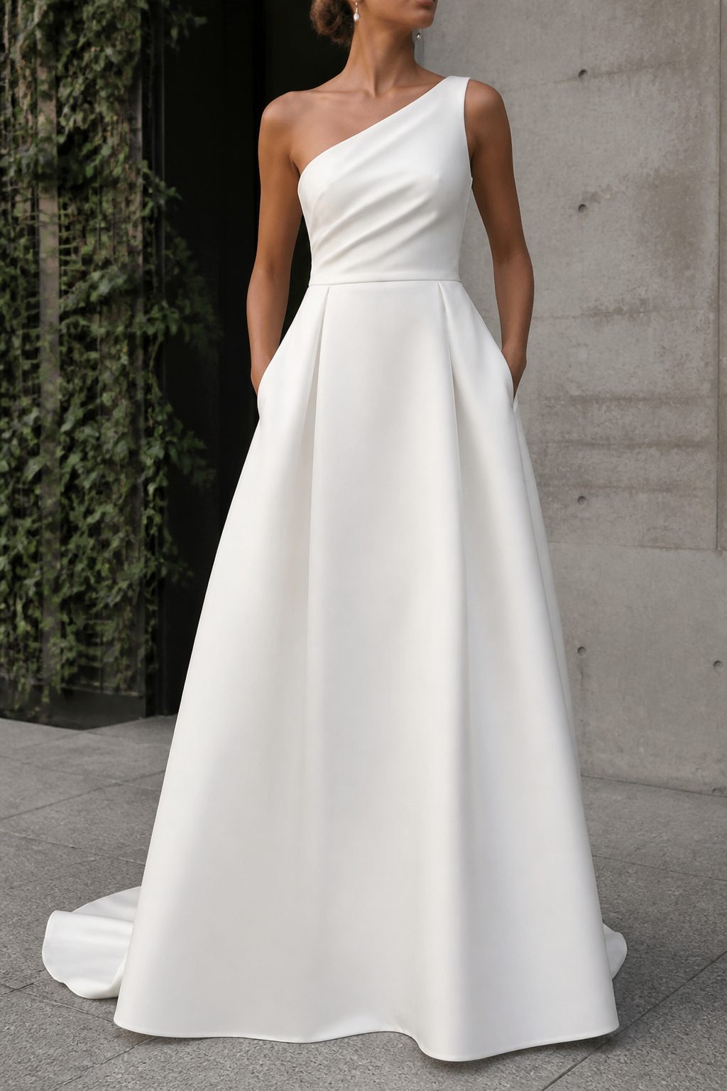One-shoulder modern wedding dress with a single strap.