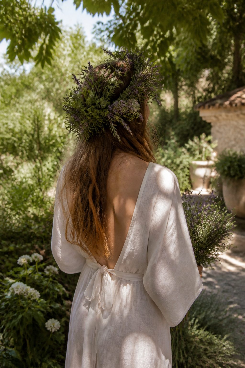 A bride with a crown of lavender and rosemary in her hair.
