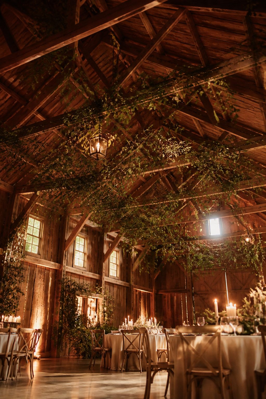 Greenery draped across the ceiling of a wedding venue.