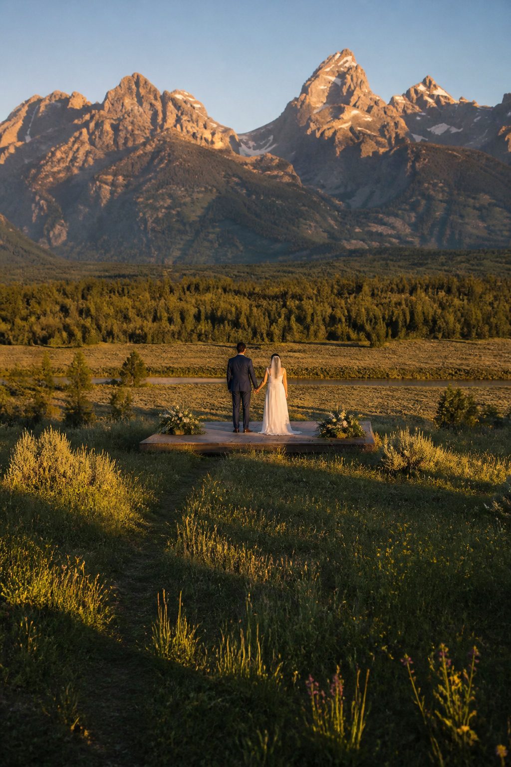 Couple exchanging vows with Grand Teton mountains in the background.