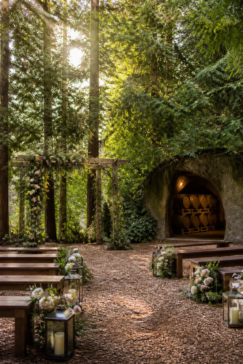 Wooded clearing with a wooden arbor at JM Cellars.