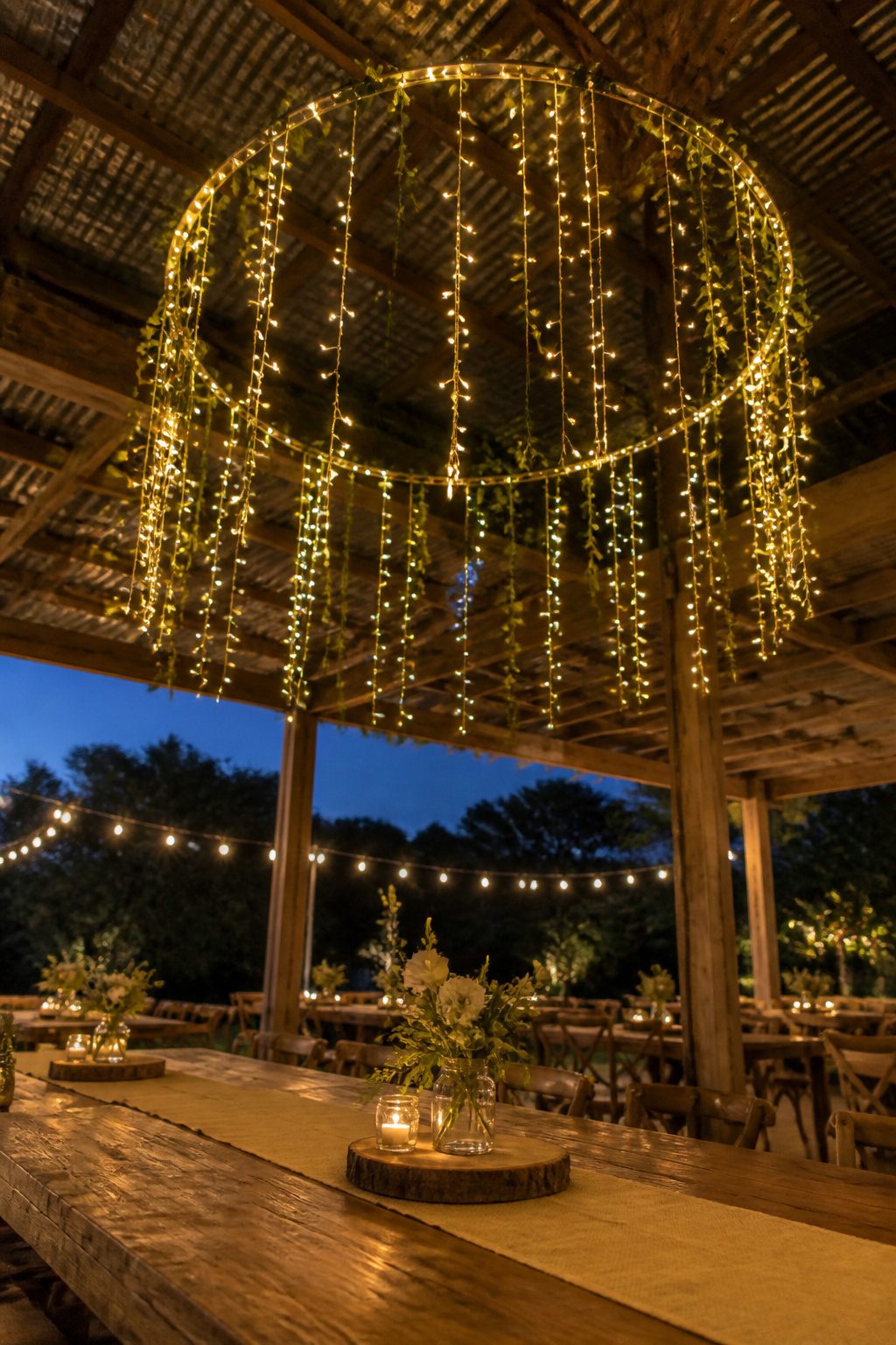A hula hoop wrapped in lights hanging from the ceiling.