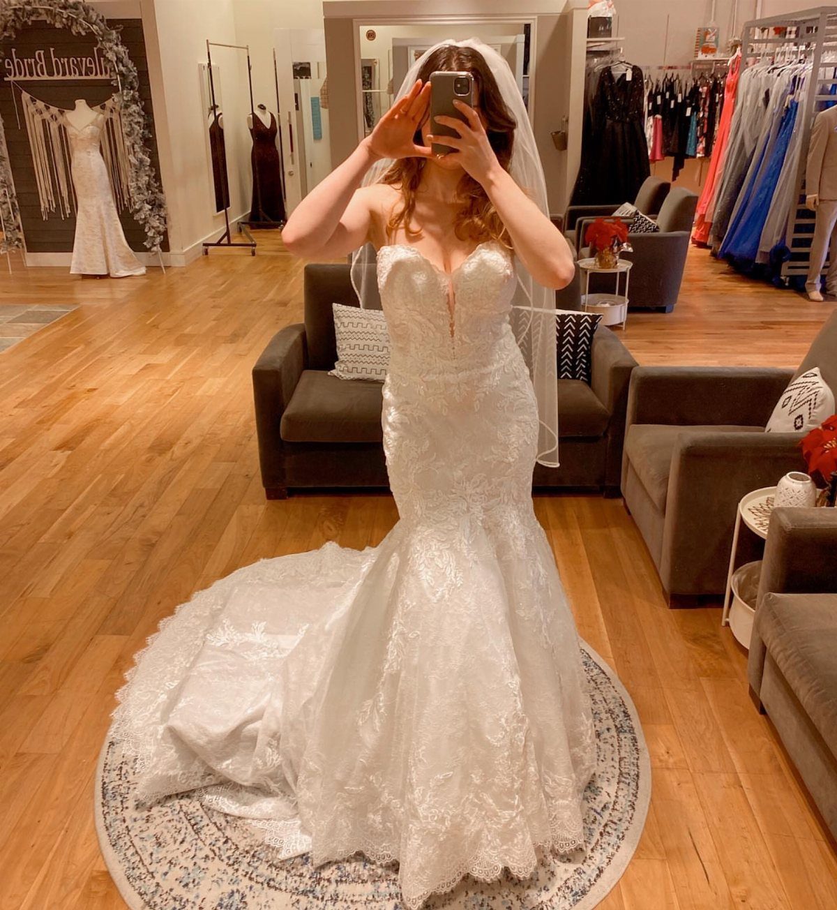 Tight Lace Wedding Dress: 8 Fitted Styles to Shape the Day 2 Woman in a white lace mermaid wedding dress with a sweetheart neckline posing in a boutique.