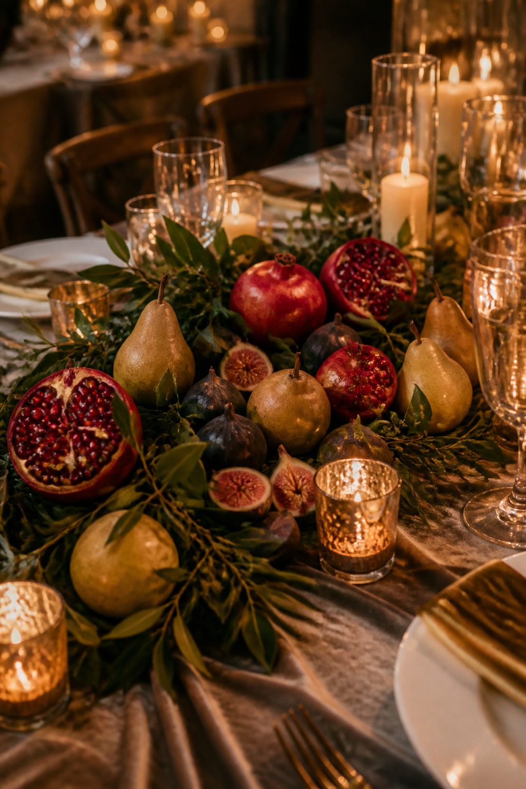 Pomegranates, figs, and pears arranged among foliage.