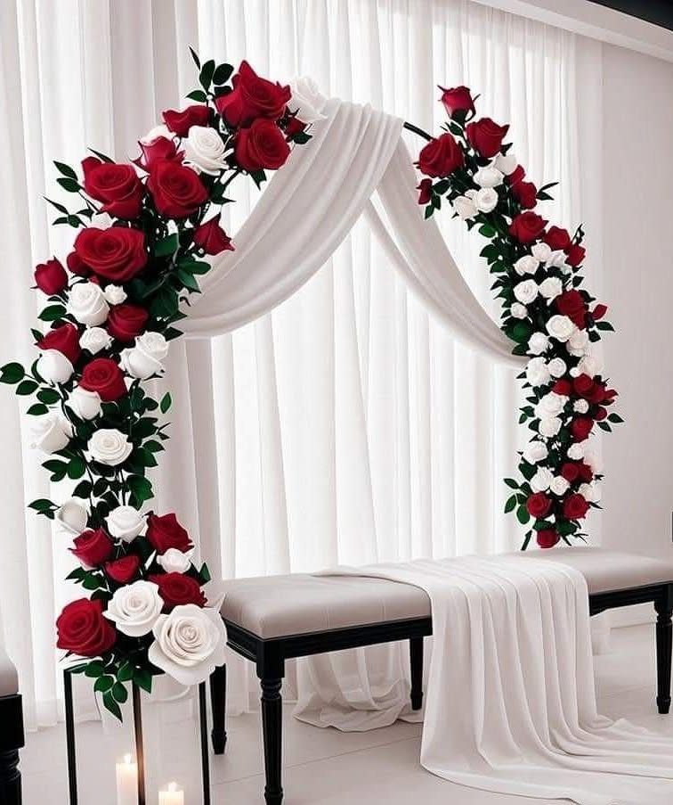 Wedding Decor with Red Roses: 9 Concepts from Pew Markers to Car Details 3 A wedding arch adorned with red and white roses and draped in white fabric.