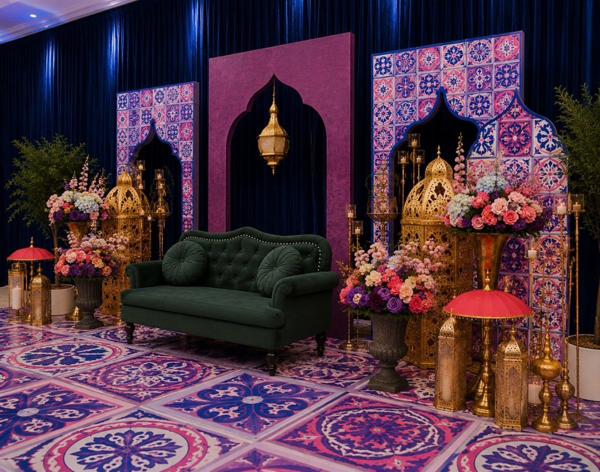 A dark green velvet sofa set against patterned Arabic-style arches and floral arrangements.