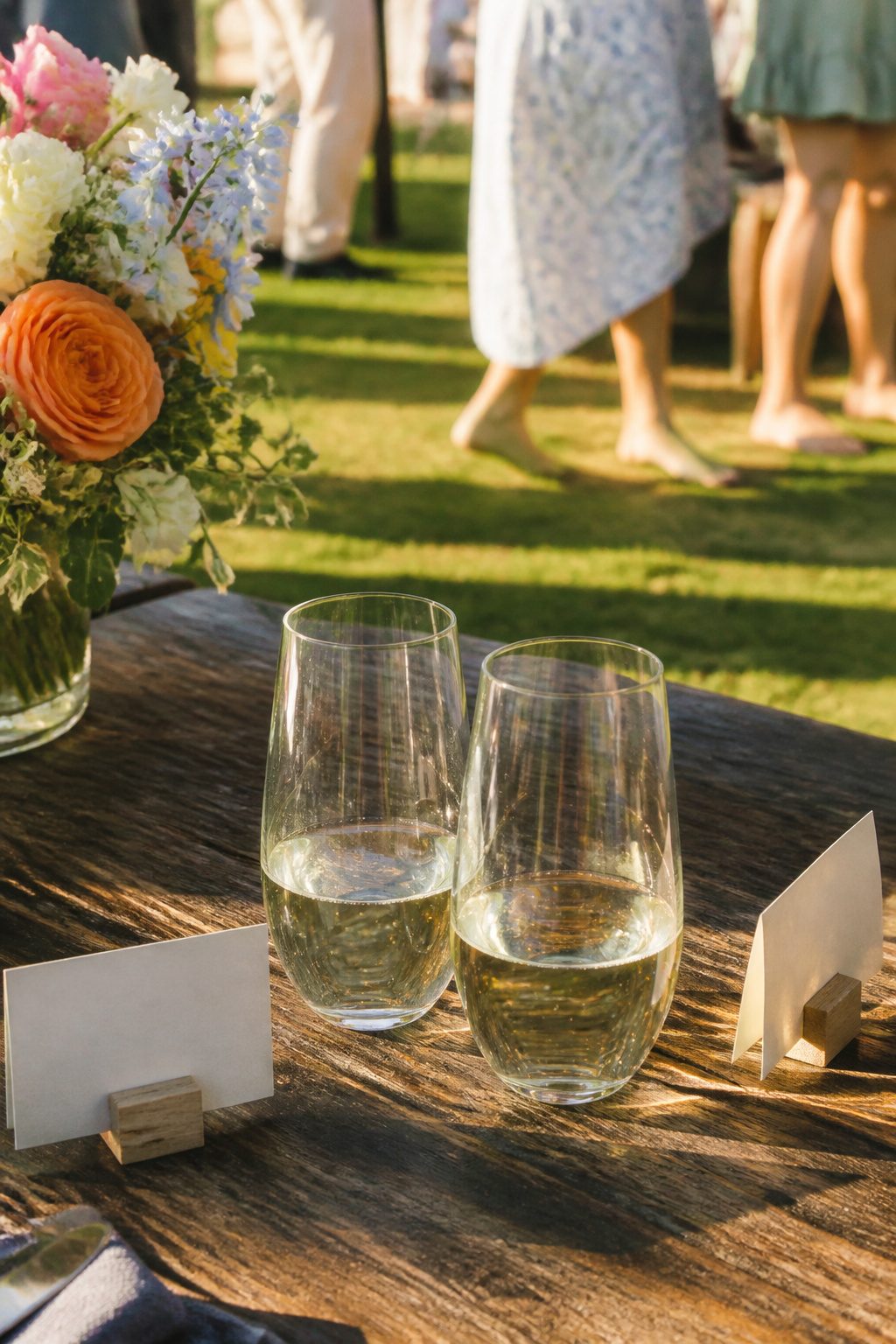 Wedding Glass Design: Personalized Glassware for Your Celebration 5 Two stemless champagne flutes with elegant engravings on a wooden table.