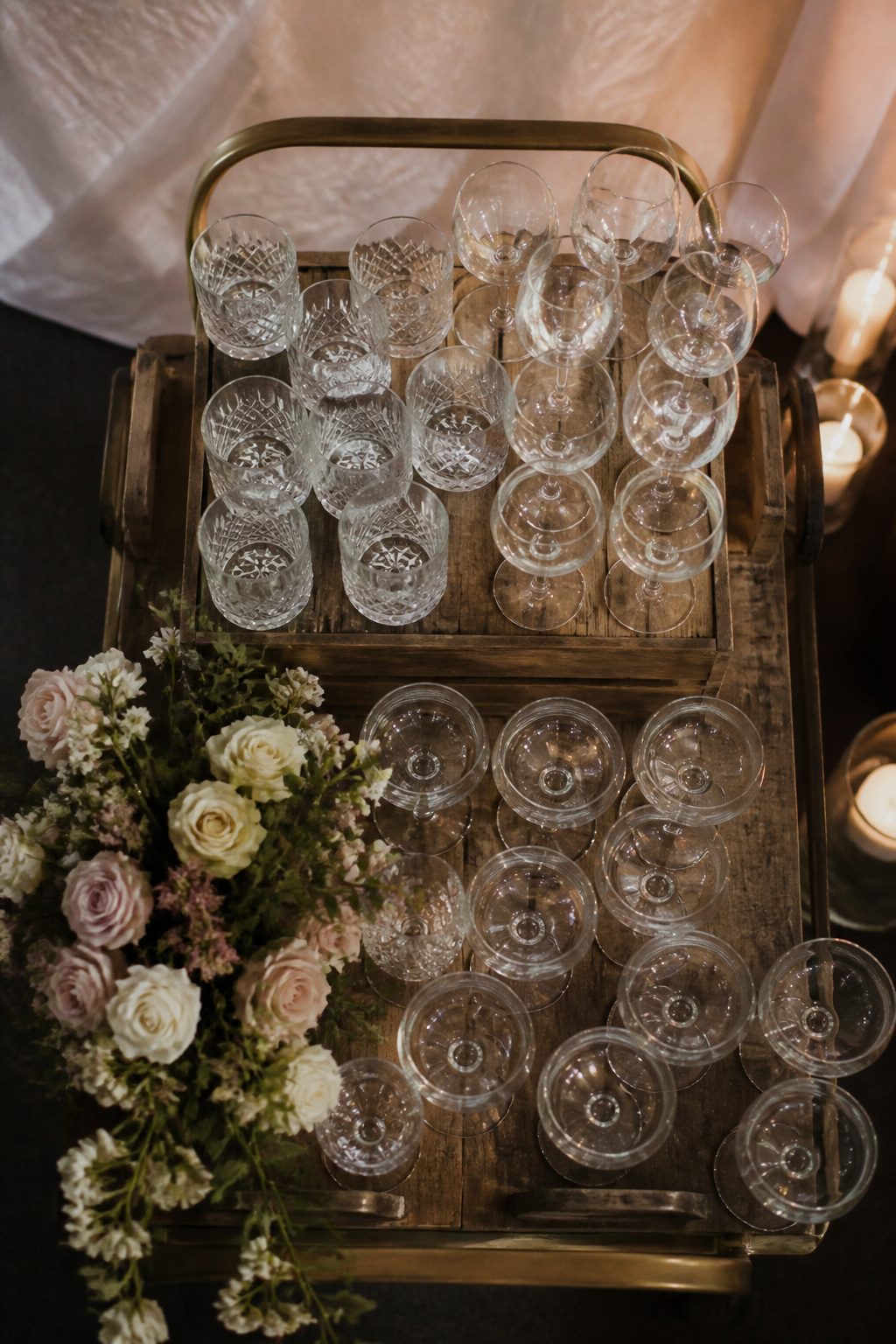 Glasses arranged in a triangle formation on a wedding table.