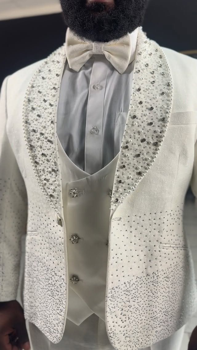 12 Wedding Groom Photos to Capture: From Getting Ready to Golden Hour 4 Close up of a man wearing an ornate white wedding suit with silver beadwork.