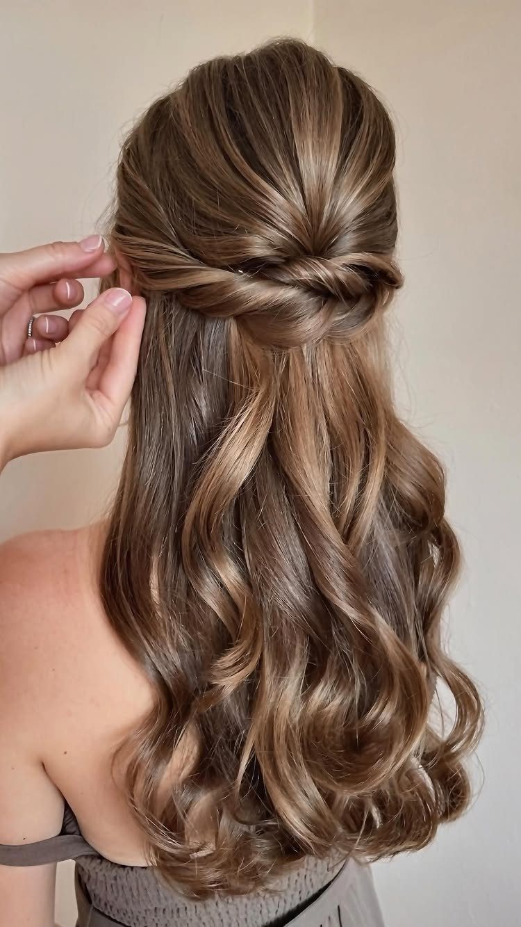 5 Wedding Hair Inspo Ideas for Brides From Loose Curls to Hollywood Waves 2 Long light brown hair styled in a romantic twisted half-up, half-down hairstyle with soft curls.