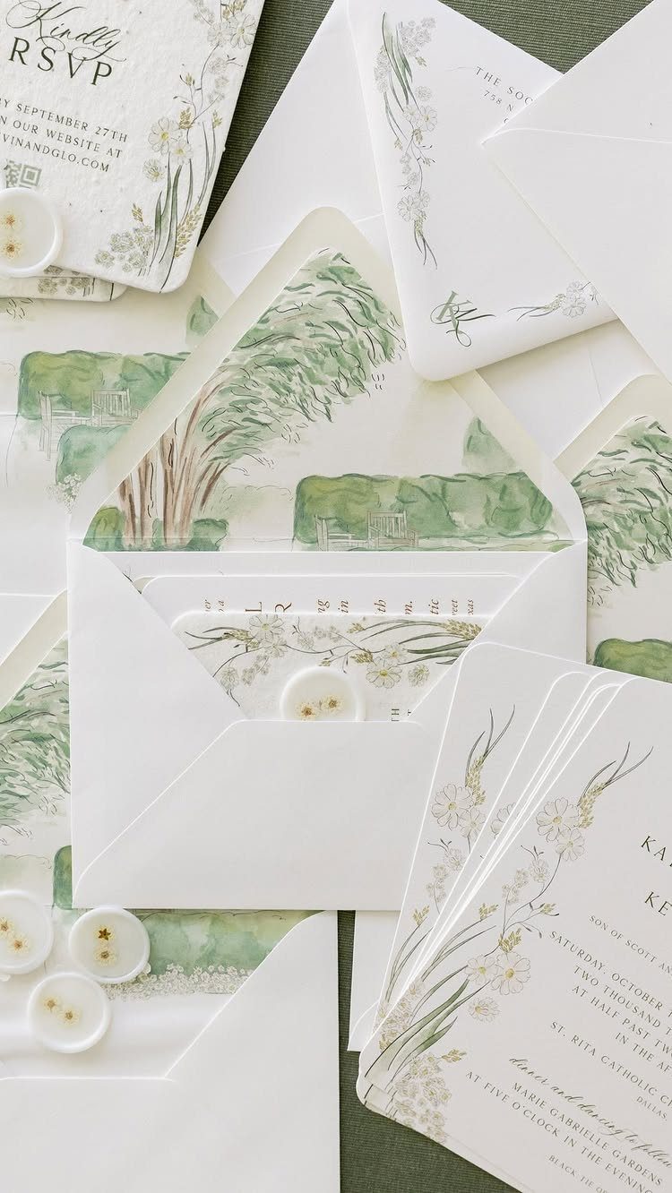 Wedding stationery with watercolor botanical illustrations and white envelopes on a dark green background.
